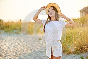 Spa wellness beach beauty woman relaxing and sun bathing on beach. Beautiful serene and peaceful young female model with