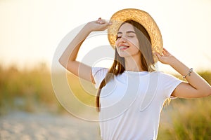 Spa wellness beach beauty woman relaxing and sun bathing on beach. Beautiful serene and peaceful young female model with