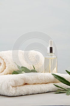 Spa and wellness composition with serum, towels and beauty products