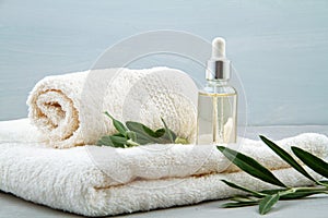 Spa and wellness composition with serum, towels and beauty products