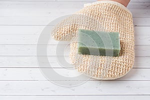 Spa and Wellness concept on white background. Washcloth mitten with soap. Copy space