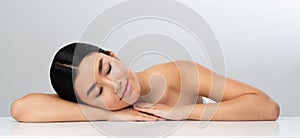 Spa and wellness. Girl relaxing after massage, grey background