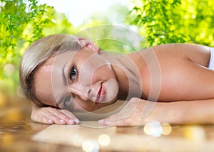 Young woman lying on hammam table in turkish bath