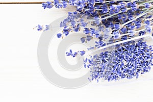 Spa and wellness setting with lavender flowers, sea salt, oil in a bottle, aroma candle on wooden white background