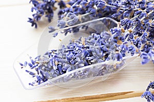 Spa and wellness setting with lavender flowers, sea salt, oil in a bottle, aroma candle on wooden white background