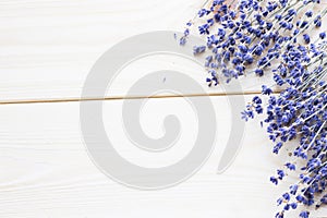 Spa and wellness setting with lavender flowers, sea salt, oil in a bottle, aroma candle on wooden white background