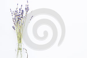 Spa and wellness setting with lavender flowers, sea salt, oil in a bottle, aroma candle on wooden white background