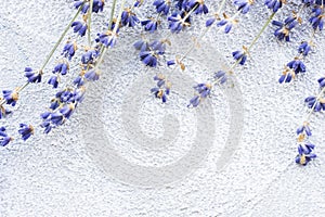 Spa and wellness setting with lavender flowers, sea salt, oil in a bottle, aroma candle on wooden white background