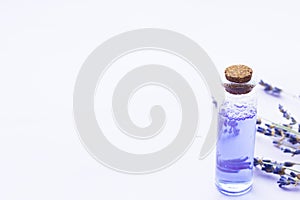 Spa and wellness setting with lavender flowers, sea salt, oil in a bottle, aroma candle on wooden white background