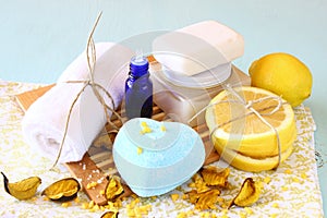 Spa and wellness setting with natural soap, candles and towel. aqua wooden background