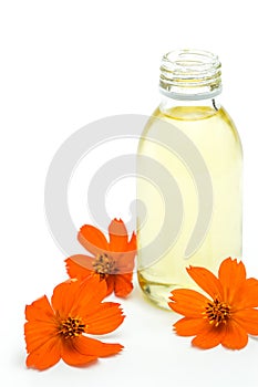 Spa and wellness setting with oil essence and flowers