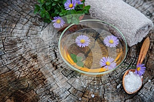 Spa and wellness setting with sea salt, oil essence, flowers