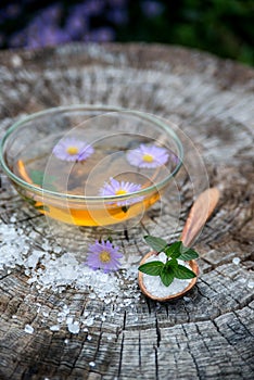 Spa and wellness setting with sea salt, oil essence, flowers and towels isolated. Relax and treatment therapy photo