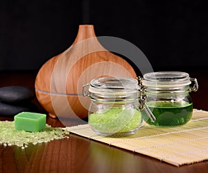 Spa and wellness setting with wooden humidifier and with green cosmetics stock images