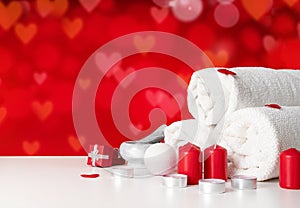 Spa and wellness, white towels and red bokeh background