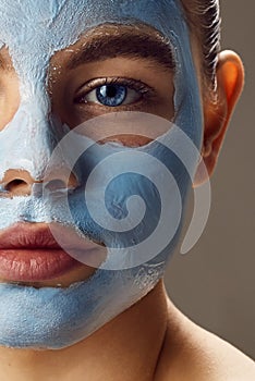 Spa Woman applying Facial clay Mask.