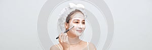 Spa woman applying facial clay mask. Banner