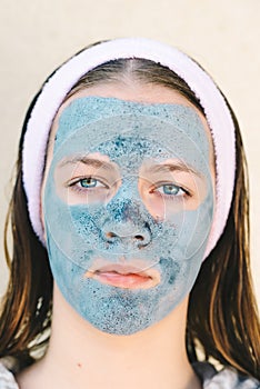 Spa woman applying facial clay mask. Beauty Treatments.