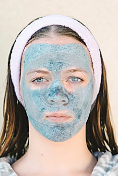 Spa woman applying facial clay mask. Beauty Treatments.