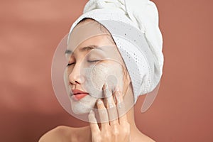 Spa Woman applying Facial clay Mask. Beauty Treatments