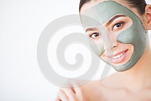 Spa Woman applying Facial cleansing Mask. Beauty Treatments