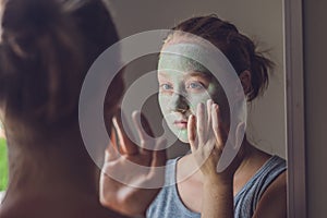 Spa Woman applying Facial green clay Mask. Beauty Treatments. Cl