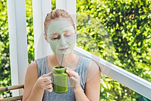 Spa Woman applying Facial green clay Mask. Beauty Treatments. Fresh green smoothie with banana and spinach with heart of sesame se