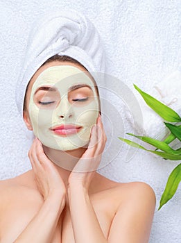 Spa woman applying facial mask