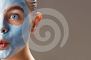 Spa Woman applying mask for face and is surprised