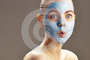 Spa Woman applying mask for face and is surprised