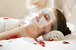 Spa Woman. Beautiful Woman Relaxes on Bed .