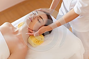 Spa Woman. Beautiful Young Woman Getting a Face Treatment at Beauty Salon. Face Massage