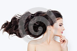 Spa woman with blowing curly hair on white background. Facial treatment, cosmetology, haircare and wellness concept