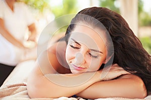 Spa Woman. Brunette Getting a Marine Algae Wrap Treatment in Spa