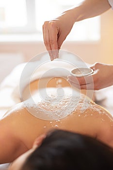 Spa Woman. Brunette Getting a Salt Scrub Beauty Treatment in the