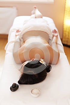 Spa Woman. Brunette Getting a Salt Scrub Beauty Treatment in the