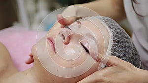 Spa woman facial Massage. Face Massage in beauty spa salon. Female enjoying relaxing face massage in cosmetology spa