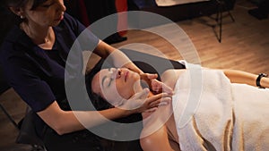 Spa woman facial massage. Face massage in beauty spa salon. Female enjoying relaxing face massage in cosmetology spa