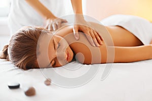 Spa woman. Female enjoying massage in spa centre.