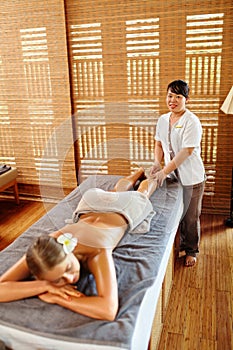 Spa Woman. Oil Leg Massage Therapy, Treatment. Body Skin Care