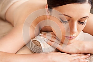 Spa, woman and relax for massage, wellness and luxury for health, calm and lying on table. Skincare, female and girl