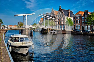 Spaarne river with boat and Gravestenenbrug bridge in Haarlem, N