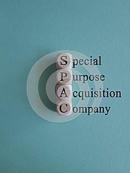 SPAC, special purpose acquisition company symbol. ?ubes with words \'SPAC\' on beautiful blue background