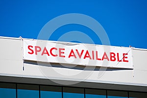 Space Available large banner on vacant commercial office building advertising the real estate, property, office for sale, rent or