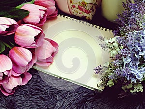 Space copy empty notebook with artificial flower background