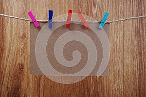 Space copy paper hang with wooden clip and rope on wooden boards background