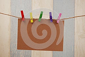 Space copy paper hang with wooden clip and rope on wooden boards background