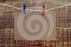 Space copy paper hang with wooden clip and rope on wooden boards background