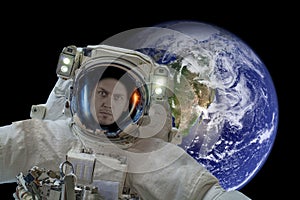 Space exploration. Astronaut in outer space. Planet earth from space on a dark background. Elements of this image were furnished