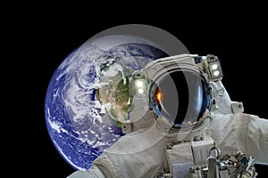 Space exploration. Astronaut in outer space. Planet earth from space on a dark background. Elements of this image were furnished